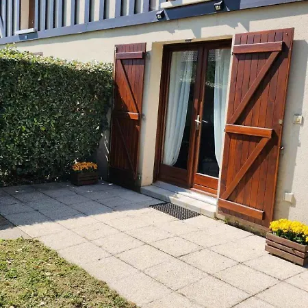 House With Garden And Barbecue In